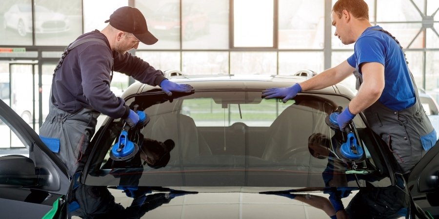 Mobile windshield repair technician replacing auto glass in Houston